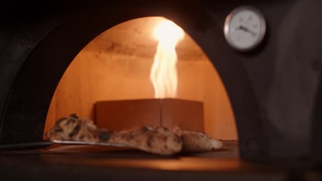 pizza baking in a wood-fired oven