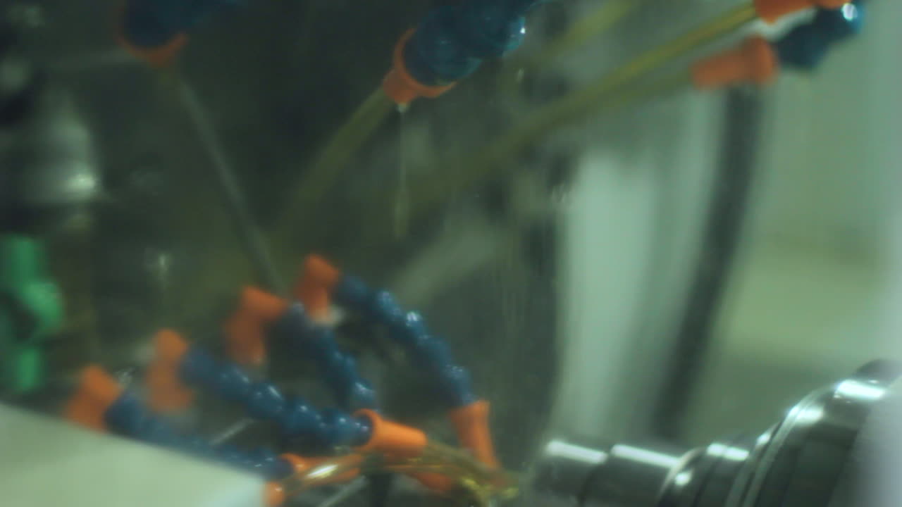 Jets of yellow liquid are used to cool metal processed on milling machine