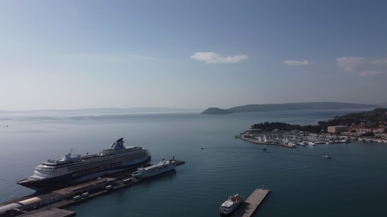 Aerial view of the city of Split from a panoramic perspective, with its medieval buildings, wooded hills, and its port with ferries on a sunny summer day with great tranquility. Split, Croatia.