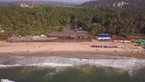drone shot flying towards the top of the sea in goa, india