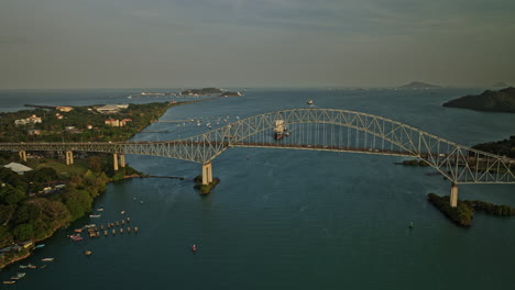 panama city aerial v48 cinematic flyover cantilever bridge of americas connecting land masses on the north and south of the panama canal at sunset golden hours - shot with mavic 3 cine - march 2022