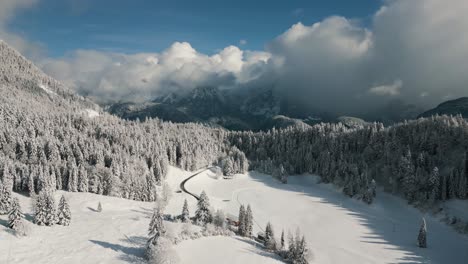 Mountain-ridge-snowy-landscape-with-snow,-sunlight-and-blue-sky