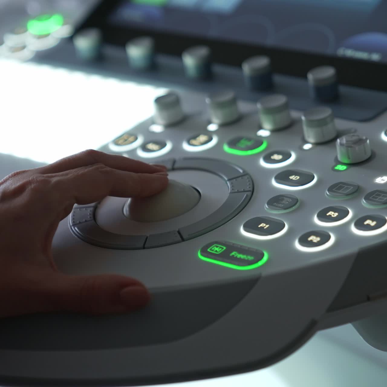 Female doctor's hand presses the buttons on the control panel of ultrasound machine. Modern equipment for sonogram diagnostics. Close up