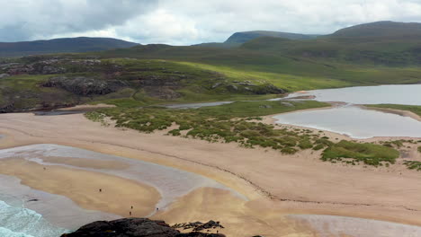 revealing drone shot of sanwood bay beach and the north atlantic ocean, a natural bay in sutherland, scotland