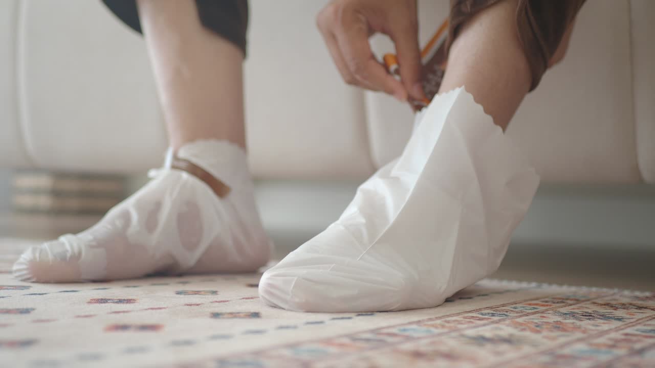 Applying foot mask for exfoliation