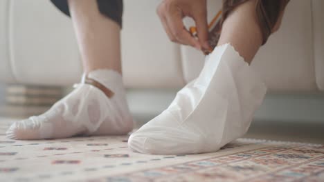 applying foot mask for exfoliation