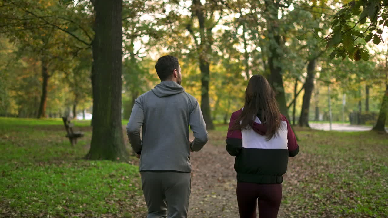 Couple jogging in a park during autumn