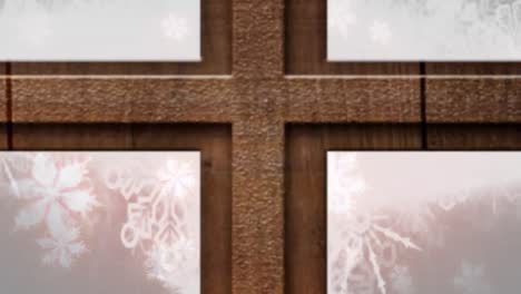 Wooden-window-frame-over-glowing-snowflakes-floating-against-red-background