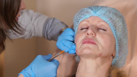 Woman receiving facial filler injection in a medical spa