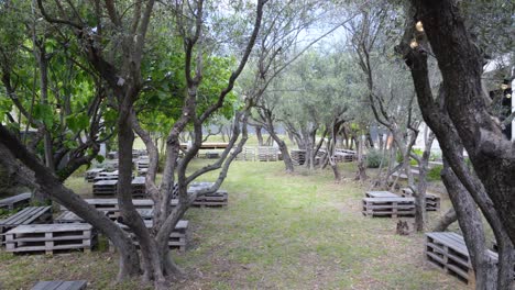 establishing shot of a wooden pallet seating area at a vinery in france