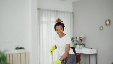 woman cleaning and dancing to music