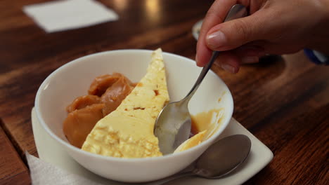 indulge in a rich colombian dessert featuring creamy arequipe and cheese. captured in warm lighting with a focus on texture, creating an inviting and appetizing scene