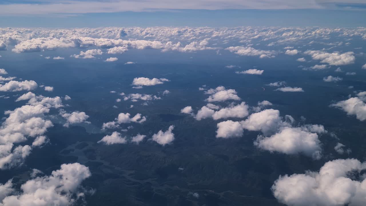 Airplane Flying Above Clouds and Landscape of Belize, Central America. Passenger Window Point of View