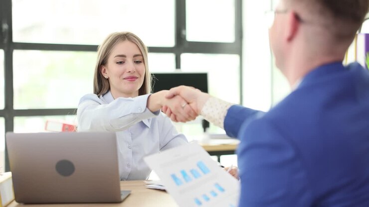Business Professionals Shaking Hands in Office