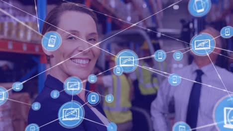 Network-of-digital-icons-against-portrait-of-caucasian-female-supervisor-smiling-at-warehouse