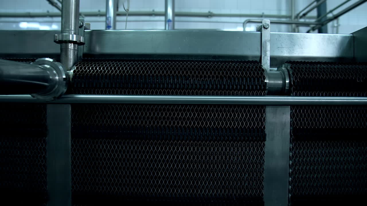 Interior of modern plant. Milk production factory with special automated equipment. Metal industrial appliances for food processing on dairy farm.