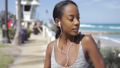 sporty woman looking away at seaside