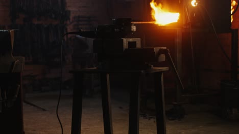 blacksmith at work in a dark forge