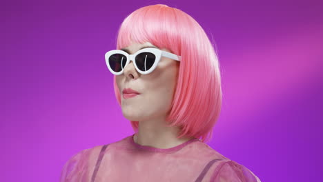 close up ofstylish woman wearing a pink wig and glasses