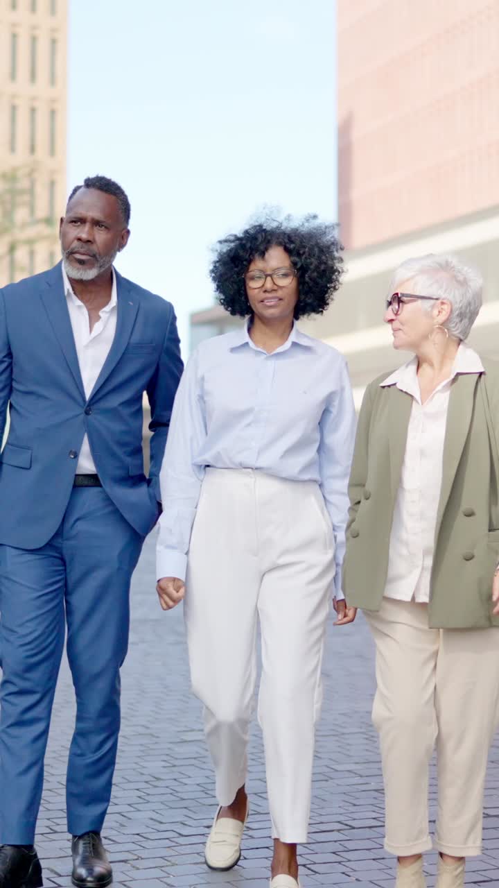 Three business people walking on a street
