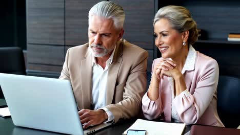 adult executives discussing a project together.