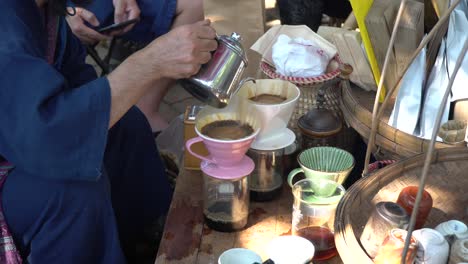 brewing a homemade cup of coffee in the street market chiang mai, thailand