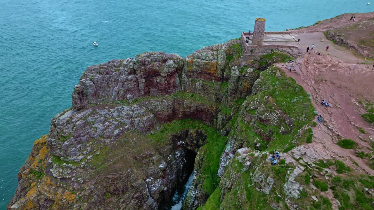 Rocky cliffside and viewpoint at Cap Fréhel peninsula above the seawater with coastal erosion, Côtes-d'Armor, Brittany, France.