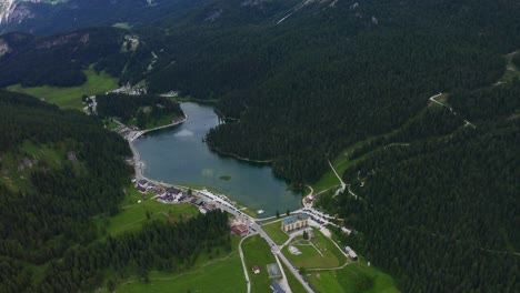 aerial view of lake misurina surrounded by dolomites alps mountains