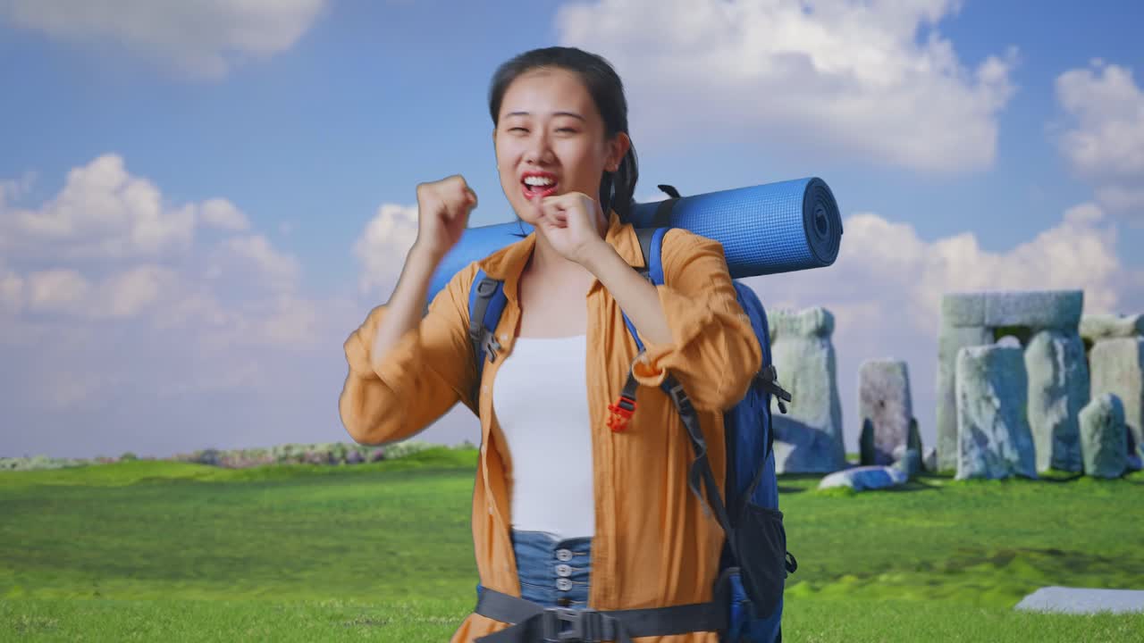 Asian Female Hiker With Mountaineering Backpack Enjoy Dancing While Traveling In Stonehenge