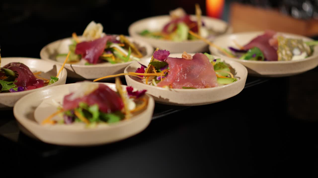 Exquisite appetizer plates with fresh sashimi, colorful garnishes, and artistic presentation