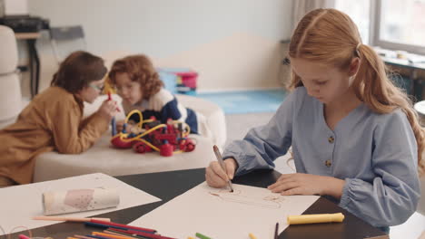caucasian schoolgirl drawing during lesson