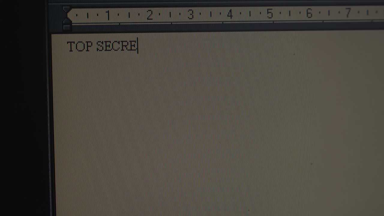 Subject 'TOP SECRET' typing on old operating system computer screen