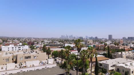 rising aerial from middle class area near hollywood california with downtown los angeles in distance