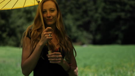 A-young-woman-opens-a-yellow-parasol-and-twirls-it-around-her-head