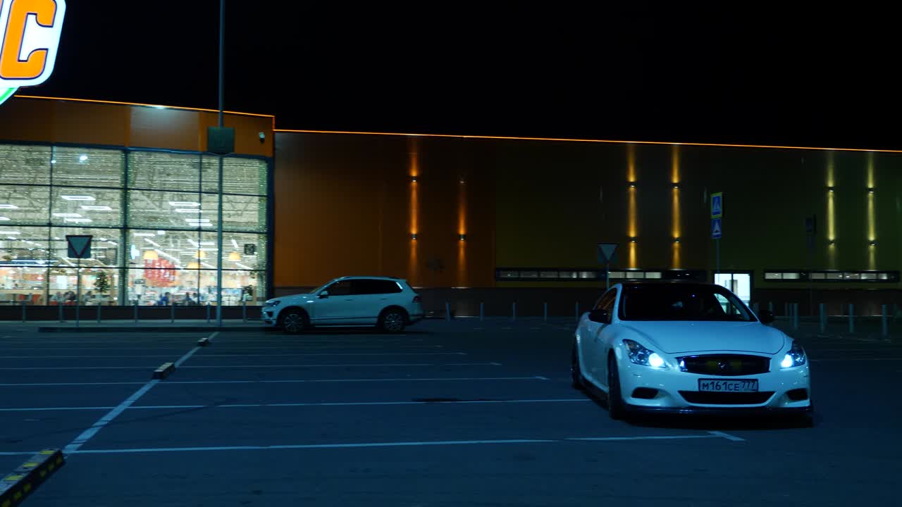 Cars parked at GloBus store at night