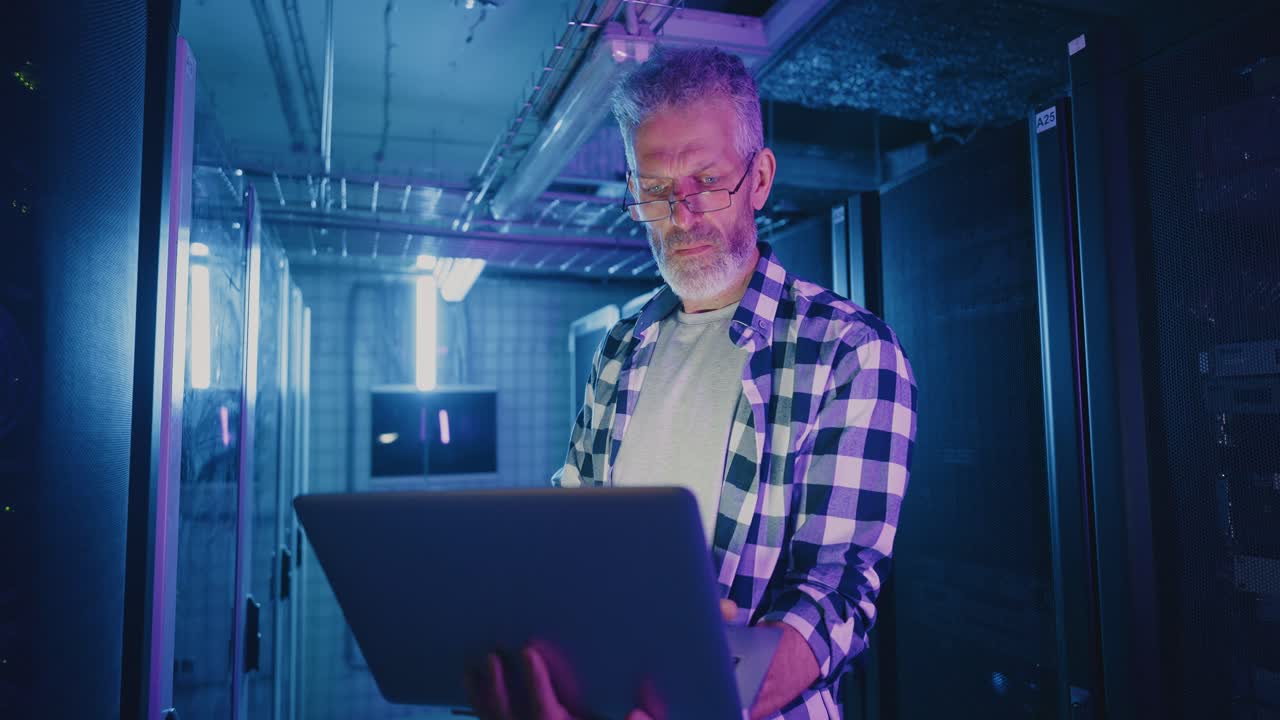 Technician working in a data center at night