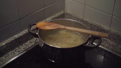 pasta-boiling-in-the-cooking-pan-in-corner-stove