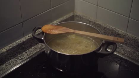 pasta boiling in the cooking pan in corner stove