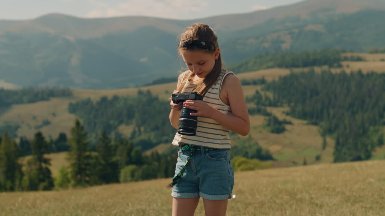 Young Girl Photographer Filming Movie Young Photographer Filming Beautiful Movie Using Digital Camera Girl Creating Content in Motion Wathing Results and Feeling Happy Spending Leisure Time Outdoor