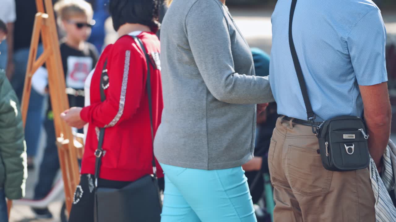Artist painting picture outdoor. Female artist working on painting on city street