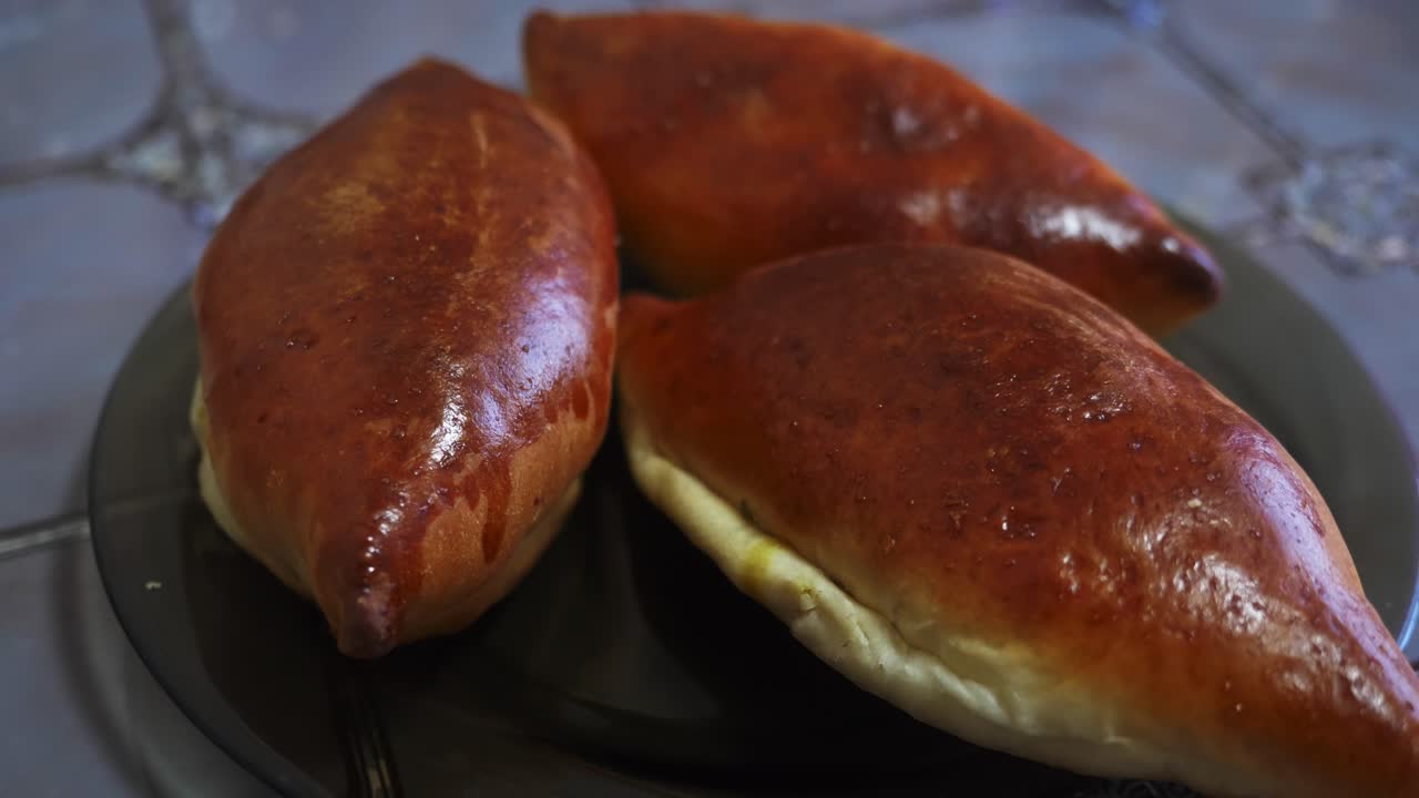 Golden-brown pastries are artfully arranged on a plate, showcasing their flaky texture. A delicious and inviting close-up of freshly baked goods