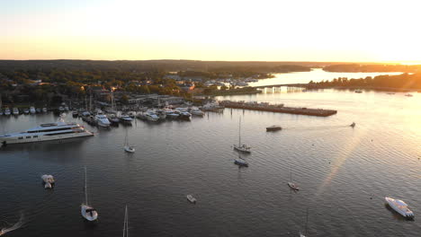 aerial, boats in a harbour at sunset in the beautiful hamptons