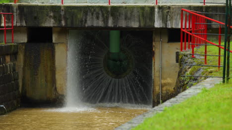 a detailed view inside the drain valve of the water tank closing the valve in slow motion with water still flowing out of the bystrička water tank