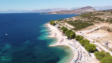 ksamil beach, albania - popular summer holiday destination - reversing aerial