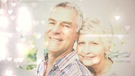 ancianos pareja sonriendo a la cámara para el día de san valentín con corazones lindos