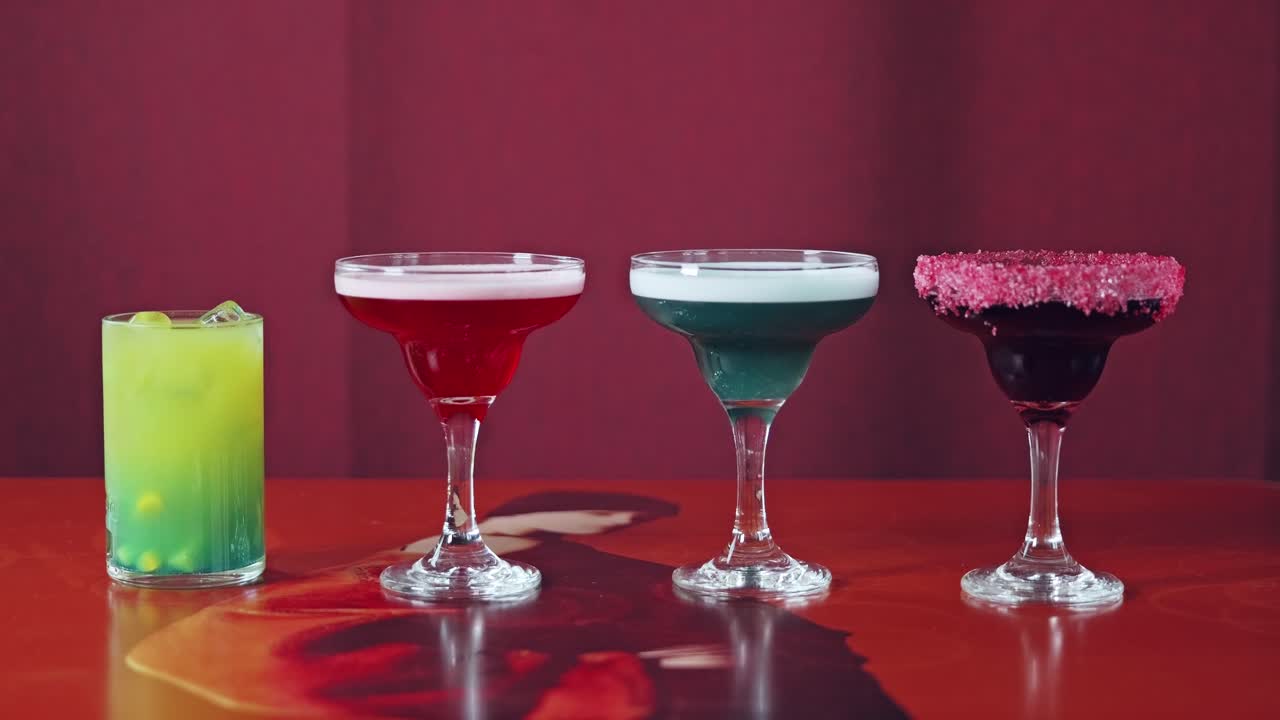 Conceptual static frame showing four drinks as isolated social reality bubbles
