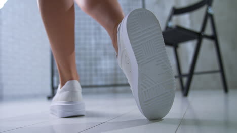 stylish white platform sneakers on a woman