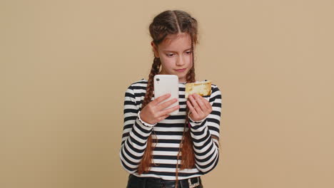 child girl use credit bank card smartphone while transferring spend money purchases online shopping