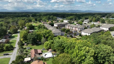 aerial approaching shot of new developed housing area with townhouses and apartments in suburbia