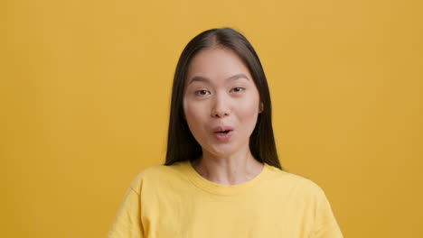 young asian woman pointing up